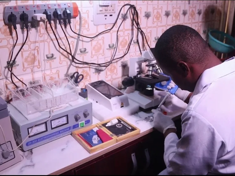 A scientist working at the laboratory bench
