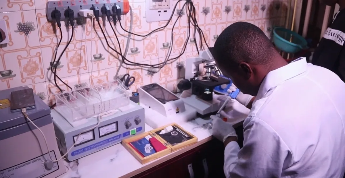 A scientist working at the laboratory bench